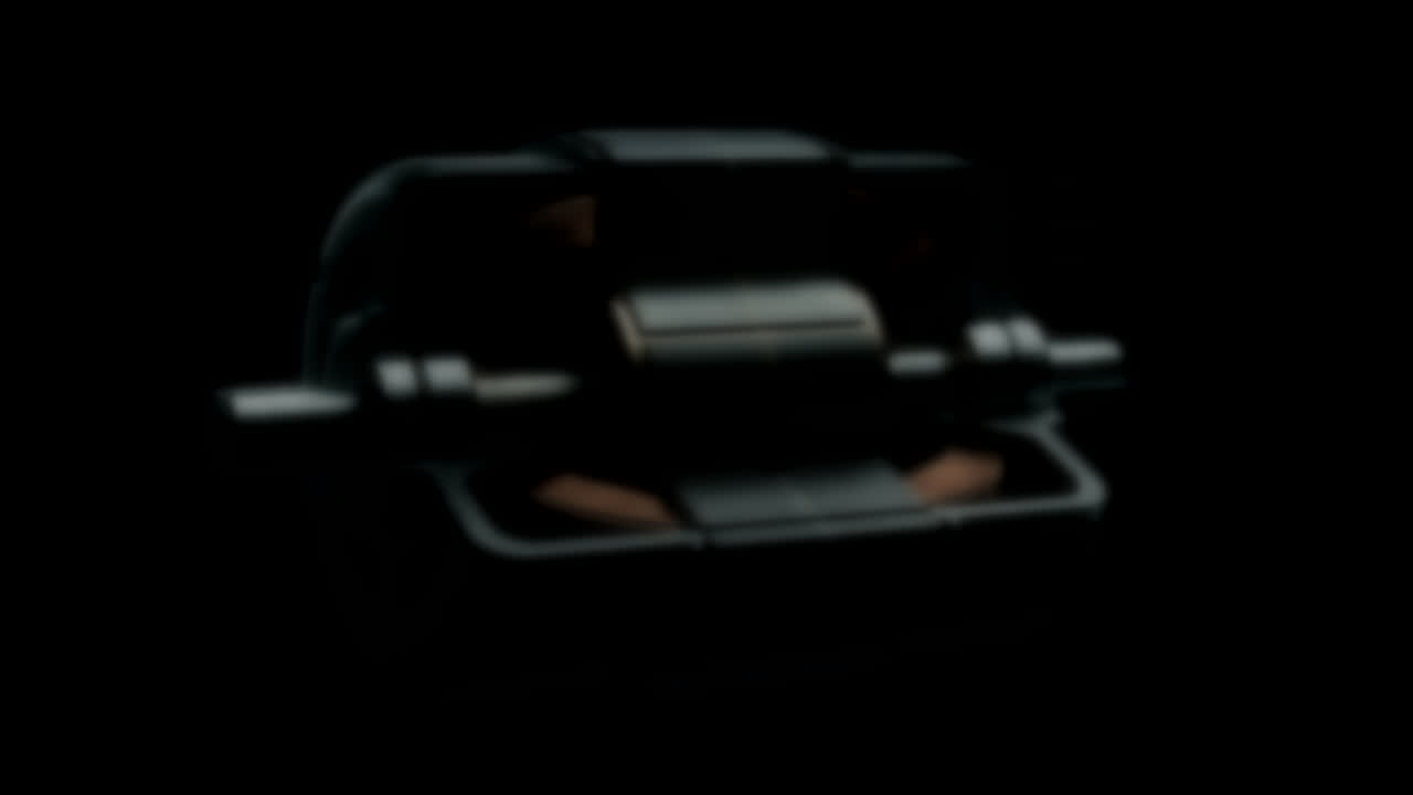 Technical cutaway of an electric motor with faintly glowing copper coils on a near-black ground